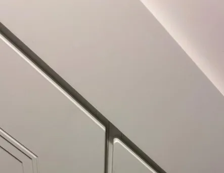Close up of the coverstrip finishing the top of the doors against the stair stringer