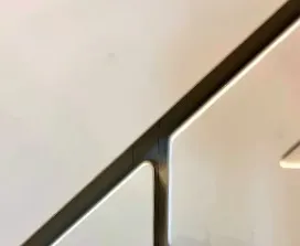 Close up of two door fronts meeting on an even shadow gap beneath the stair stringer
